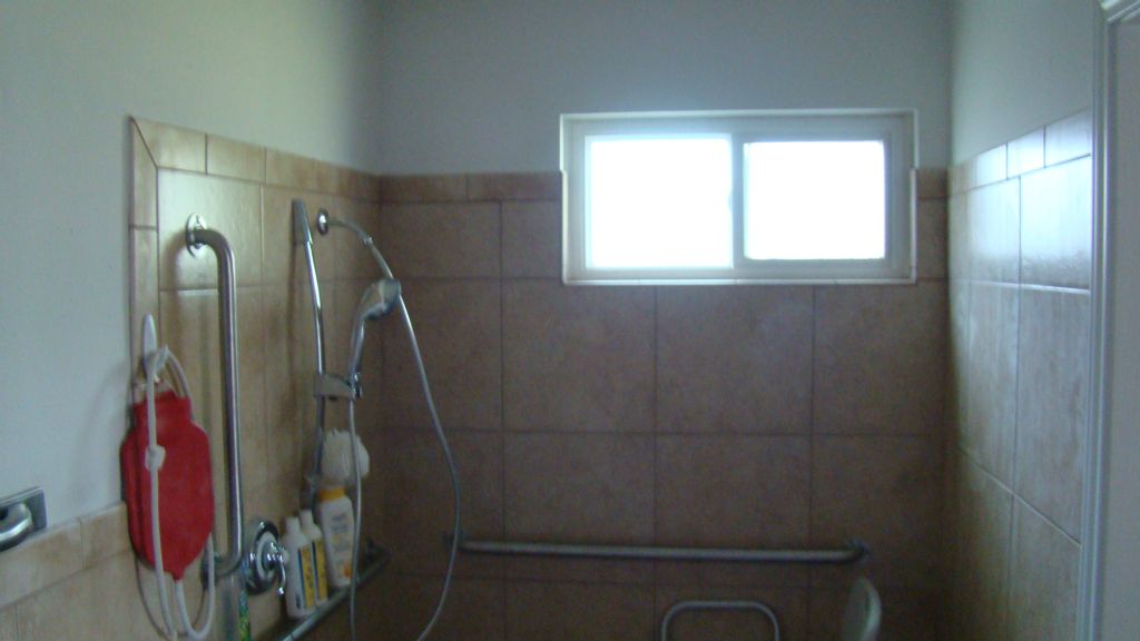 Completed wheelchair accessible shower with ADA rails & fixtures